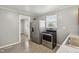 Well-lit kitchen featuring stainless steel appliances, grey walls, tile flooring, and lots of natural light at 2336 St Paul St, Indianapolis, IN 46203