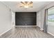 Bright living room features a stylish accent wall and modern ceiling fan at 2336 St Paul St, Indianapolis, IN 46203