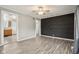 Inviting living room with an accent wall and open access to the adjacent kitchen at 2336 St Paul St, Indianapolis, IN 46203
