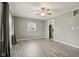 Spacious living room with gray walls, wood-look floors, and a ceiling fan at 2336 St Paul St, Indianapolis, IN 46203