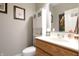 Bright, clean half bathroom with updated vanity, toilet, and storage cabinet, perfect for guests at 2889 Grimes Way, Columbus, IN 47201