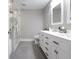 Bright bathroom featuring a double sink vanity, toilet, and glass enclosed walk-in shower at 2889 Grimes Way, Columbus, IN 47201