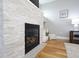 Fireplace and hardwood floors that lead to a side table with white lamp and wood accents at 2889 Grimes Way, Columbus, IN 47201