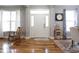 Inviting foyer with gleaming hardwood floors, bright windows, and a rocking chair at 2889 Grimes Way, Columbus, IN 47201