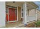 Welcoming front porch with a bright red door, white columns, and decorative accents at 2889 Grimes Way, Columbus, IN 47201
