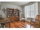 Bright home office featuring hardwood floors, large windows, and a vintage bookcase at 2889 Grimes Way, Columbus, IN 47201