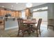 Eat in kitchen showcasing light wooden cabinets, stainless steel appliances, and barstool seating at 2889 Grimes Way, Columbus, IN 47201