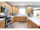Bright kitchen with stainless steel appliances, beautiful backsplash, and tile flooring at 2889 Grimes Way, Columbus, IN 47201