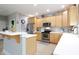 Well-lit kitchen with wooden cabinets, stainless steel appliances, and stylish mosaic backsplash at 2889 Grimes Way, Columbus, IN 47201