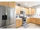 Modern kitchen with stainless steel fridge and appliances, plenty of cabinet space at 2889 Grimes Way, Columbus, IN 47201