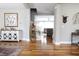 Open-concept living room with hardwood floors and stylish decor, leading to the staircase at 2889 Grimes Way, Columbus, IN 47201