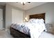 A well-lit main bedroom featuring a wooden bed frame, and closet with sliding doors at 2889 Grimes Way, Columbus, IN 47201