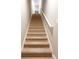 Carpeted stairway with white railing leading to the upper level at 2889 Grimes Way, Columbus, IN 47201