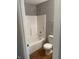 Bathroom featuring a tub and shower combo, toilet, and wood-look flooring at 2968 N Gale St, Indianapolis, IN 46218