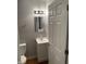 Bathroom featuring a vanity sink, mirror, toilet, modern lighting, and wood-look floors at 2968 N Gale St, Indianapolis, IN 46218