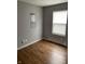 Bedroom featuring wood-look flooring, a window, and neutral gray paint at 2968 N Gale St, Indianapolis, IN 46218