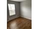 Bedroom featuring wood-look flooring, a window, and neutral gray paint at 2968 N Gale St, Indianapolis, IN 46218