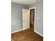 Bedroom with wood-look flooring, gray walls, and white doors at 2968 N Gale St, Indianapolis, IN 46218
