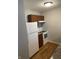 Kitchen with white refrigerator, range, and wooden cabinetry at 2968 N Gale St, Indianapolis, IN 46218