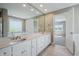 Bright bathroom featuring dual vanity with marble countertop, tub, and shower at 3256 Waterside Ct, Greenwood, IN 46143