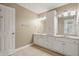 Well-lit bathroom featuring double sinks with ample counter space and a full-length cabinet at 3256 Waterside Ct, Greenwood, IN 46143