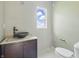 Modern bathroom with unique sink, dark wood cabinet, and natural light at 3256 Waterside Ct, Greenwood, IN 46143
