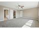 Large bedroom with ceiling fan, multiple doors and sunlight streaming in at 3256 Waterside Ct, Greenwood, IN 46143