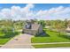 An aerial view shows the beautiful two-story home with attached three-car garage and a pond behind the house at 3256 Waterside Ct, Greenwood, IN 46143