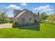 A two-story home features brick and siding, plus an attached three-car garage and well manicured lawn at 3256 Waterside Ct, Greenwood, IN 46143