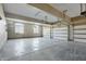 Clean, empty garage with concrete floor, garage doors and storage shelves at 3256 Waterside Ct, Greenwood, IN 46143