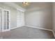 Home office features built-in bookcase, neutral colors, and ample lighting at 3256 Waterside Ct, Greenwood, IN 46143