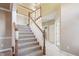 Traditional staircase features carpeted steps, wooden banister, and neutral tones throughout entryway at 3256 Waterside Ct, Greenwood, IN 46143
