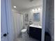 Elegant bathroom with a navy blue vanity and a shower curtain at 3806 Sycamore Bend S Way, Columbus, IN 47203