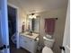 Cozy bathroom with a granite countertop and a decorative mirror at 3806 Sycamore Bend S Way, Columbus, IN 47203