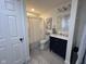 Elegant bathroom with a navy blue vanity and a tiled floor at 3806 Sycamore Bend S Way, Columbus, IN 47203