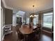 Spacious dining room with hardwood floors, chandelier, and open access to other living areas at 3806 Sycamore Bend S Way, Columbus, IN 47203