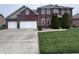 Beautiful brick two-story home with attached two car garage and mature landscaping at 3806 Sycamore Bend S Way, Columbus, IN 47203