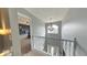 Upstairs hallway featuring a chandelier and a view of the living room at 3806 Sycamore Bend S Way, Columbus, IN 47203