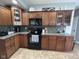 Updated kitchen with stainless steel appliances, granite countertops, and dark wood cabinets at 3806 Sycamore Bend S Way, Columbus, IN 47203