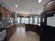 Well-equipped kitchen with dark wood cabinetry, granite counters, and stainless steel appliances at 3806 Sycamore Bend S Way, Columbus, IN 47203