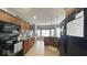 Spacious kitchen featuring wooden cabinetry, black appliances and a breakfast nook at 3806 Sycamore Bend S Way, Columbus, IN 47203