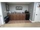 Basement kitchenette area with a fridge and cabinets at 3806 Sycamore Bend S Way, Columbus, IN 47203