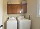 A functional laundry room with cabinetry above a washer and dryer at 3806 Sycamore Bend S Way, Columbus, IN 47203