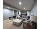 Large living room with an oversized sectional and an ottoman at 3806 Sycamore Bend S Way, Columbus, IN 47203