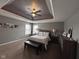 Spacious main bedroom featuring tray ceilings, a ceiling fan and ample natural light at 3806 Sycamore Bend S Way, Columbus, IN 47203