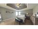 Spacious main bedroom featuring tray ceilings, a ceiling fan, and neutral paint at 3806 Sycamore Bend S Way, Columbus, IN 47203