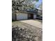A two-story home features a two-car garage and a concrete driveway with tree at 4217 Carson Ln, Indianapolis, IN 46227