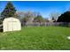 Spacious backyard featuring a green lawn, wooden fence, and storage shed at 439 Pleasantview Dr, Greenwood, IN 46142