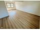 Bright bedroom with wood floors and a window offering views of the outdoors at 439 Pleasantview Dr, Greenwood, IN 46142