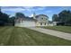 View of the home's exterior with attached garage and driveway, set amidst a lush, green landscape at 439 Pleasantview Dr, Greenwood, IN 46142